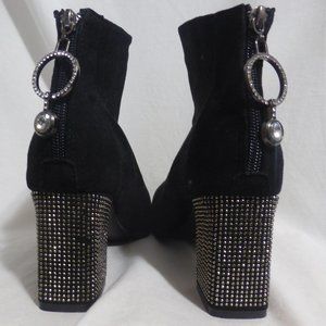 Black suede boots with rhinestones detail on the heel and on the zip pull charm